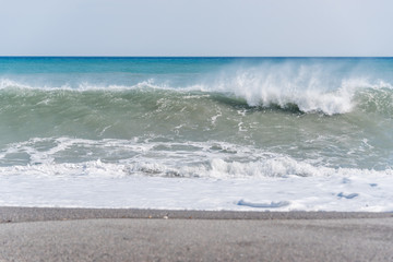 Cloudscape and Volcanic Black Sand Beach and Blue Ionian Sea in Sicily