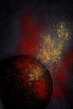 From above picture of composition of black dish and spices