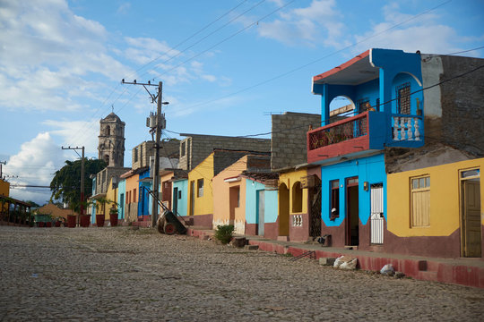 CUBA - DECEMBER 28, 2018: Old colourful houses on wide asphalt street and blue sky with clouds