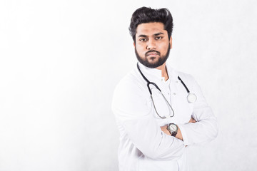 Fototapeta premium Handsome young doctor in a white coat with a stethoscope. Health care concept.