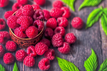 raspberry berries close-up. background with raspberry in wooden bowl on table.