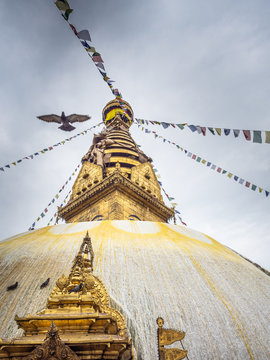 NEPAL, BOUDHANATH STUPA - AUGUST 19, 2014: top of boudhanath stupa temple with color flags decorating