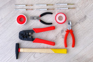 Flat lay of tools, parts, hammer and pliers on white wooden background, close up. Repair in home or apartment with special tools. Diy repairs. Top view.