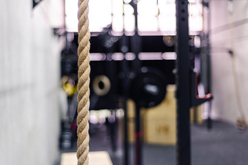 Closeup rope hanging near wall in gym