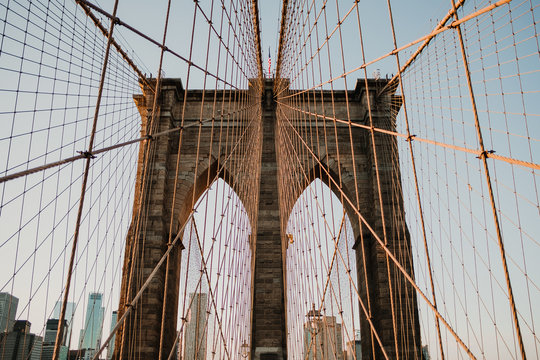 Perspective view of beautiful bridge gates with cables on background of New York city
