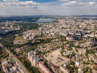 Naklejka premium landscape view over city on summer sunny day with clouds aerial and view to lake