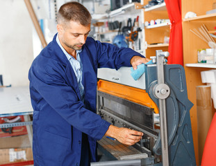 portrait of a working man at printer studio