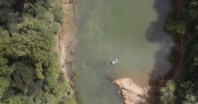 Aerial 4k bird's eye view drone shot above fly fishermen casting for fish in drift boat in the Chattahoochee river