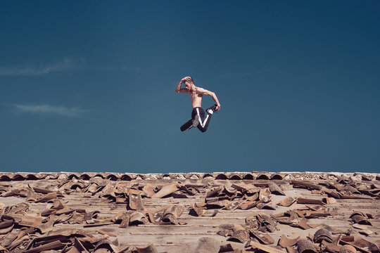 Man doing handstand on roof