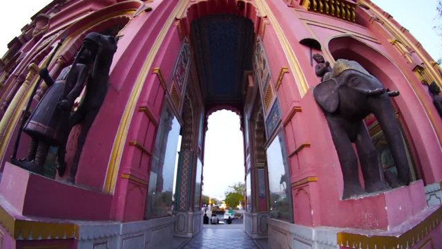 Panning down from outside arch of patrika gate to the pillars and carved statues outside it in jaipur india asia