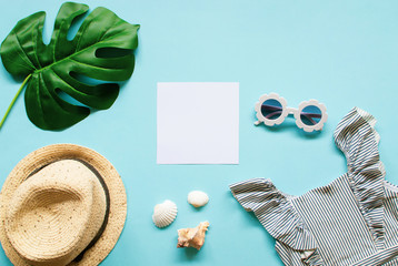 Composition of white modern sunglasses, tropical leaves on blue background. Beach relax. Summer creative concept. Flat Lay. Top View