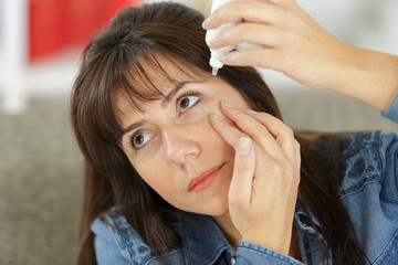 Naklejka premium beautiful woman with eyedrops