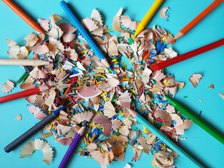 Shaving from multicolored pencils as background.