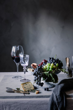 Grapes with wine and blue cheese served on table for dinner