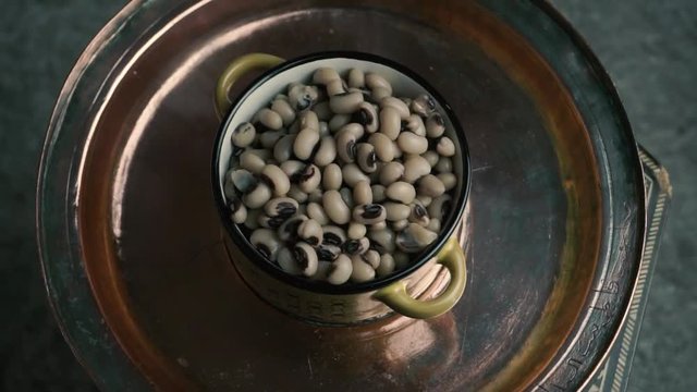 Dry cowpea in yellow bowl on copper tray. Vegetarian food with high vegetable protein. Healthy food concept