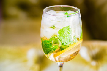 Glass with delicious fresh homemade mojito on blurred background
