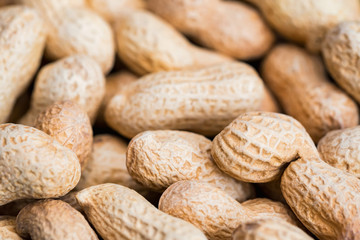 Close up unpeeled peanuts for background image