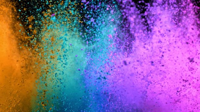 Super Slowmotion Shot of Color Powder Explosion Isolated on Black Background.
