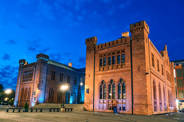 Fototapeta premium Neo-Gothic, historic building of the red brick town hall during the night in Kolobrzeg..