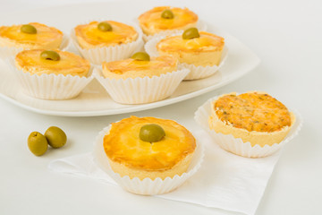 Small brazilian chicken pies are set on a white background.