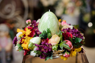 Bright spring composition with multicolor flowers and big egg candle
