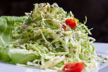 Salad with cabbage and dill in a bowl. Close up