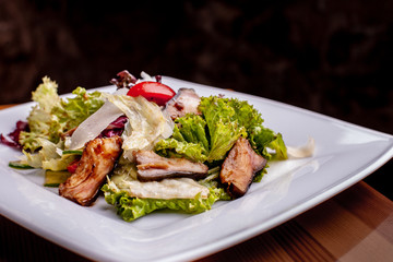 Salad with smoked catfish, carrots and miso dressing.The work of a professional chef. Dish from a restaurant Close-up.