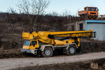Construction utility Vehicles parked near the construction site in the rural area