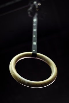 Gymnastic ring hanging in gym on blurred background