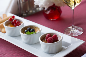 creme brulee with berries In restaurant 