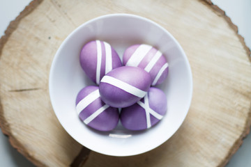 purple Easter egg on a wooden stand