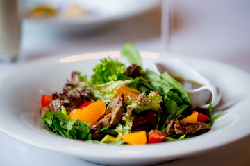 salad with beef and sauce. Dinner in restaurant