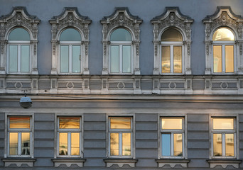 Palace facade on the Ringstrasse with interesting architecture, color and illuminated windows in...