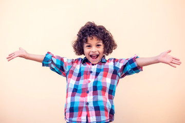 Young boy kid shows hugs with open arms