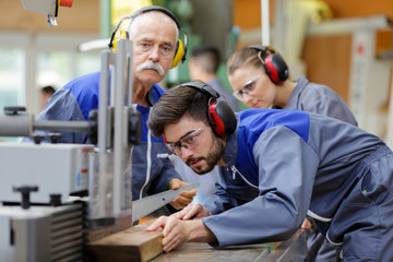 young man working in carpenting studio