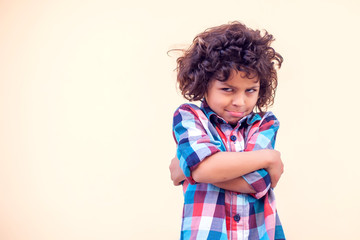 Closeup portrait shy little kid with curly hair
