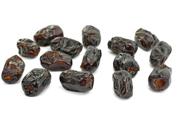 Dried dates over white background. Heap of dried dates isolated on white background.