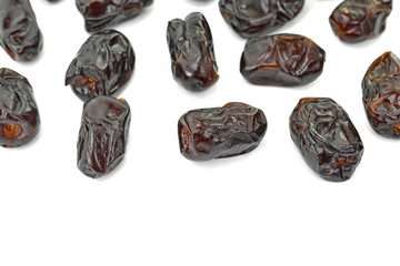 Dried dates over white background. Heap of dried dates isolated on white background.