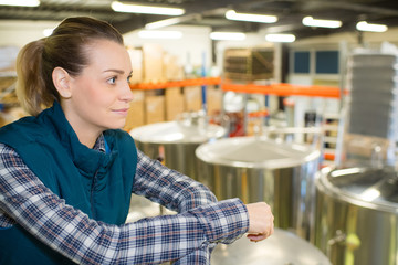 worker looking at the stainless steel container