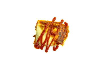 Portion of tasty lasagna. An isolated traditional lasagna made with minced beef bolognaise sauce. Tasty serving of traditional Italian lasagne with spicy tomato based ground beef and melted mozzarella