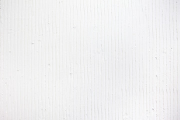 textured white background with plaster vertical lines and stripes