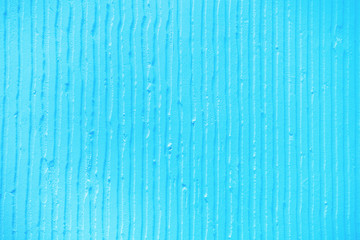 textured blue background with plaster vertical lines and stripes