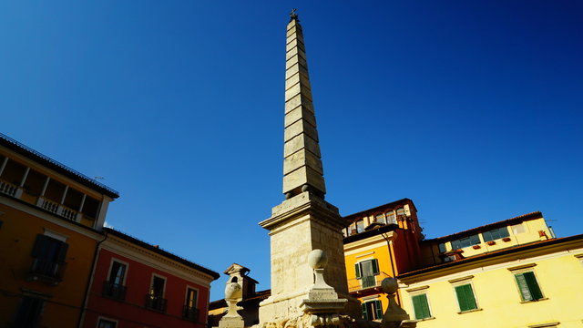 Tagliacozzo, Italy - 27th July 2018: panoramic view of Piazza dell'Obelisco in the center of the village with the characteristic fountain with an obelisk