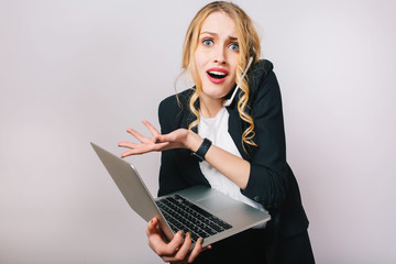 Portrait modern funny blonde office woman in white shirt and black jacket on white background. Working with laptop, being busy, talking on phone, astonished, problems, expressing true emotions