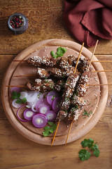 Beef liver on skewers with sesame seeds on wooden tray. Liver Kebab, kabob - image