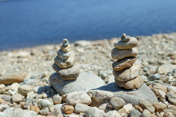 Fototapeta na wymiar Two stacks of rocks on the beach