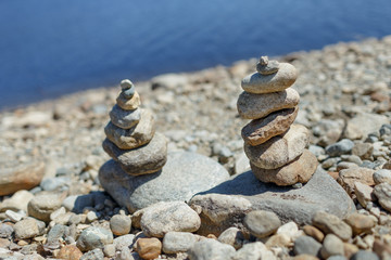Fototapeta na wymiar Two stacks of rocks on the beach