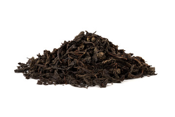 Black tea on a white background. A pile of dried tea leaves on a white background.