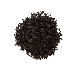 Black tea on a white background. A pile of dried tea leaves on a white background.