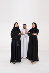 Two arab females with one male smiling and standing on white background